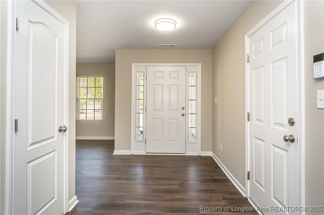 2830 John McMillan Road Hope Mills, NC 28348 - Photo 2 of 46 a view of a hallway with wooden floor and stairs