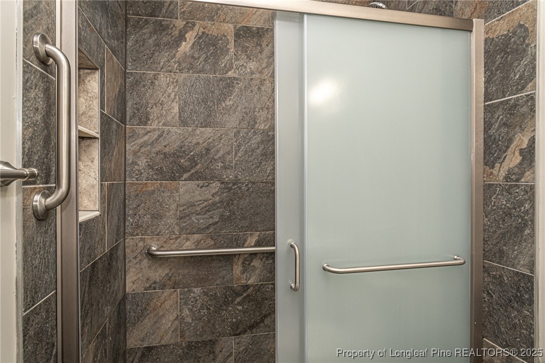 2830 John McMillan Road Hope Mills, NC 28348 - Photo 27 of 46 a bathroom with a glass shower door