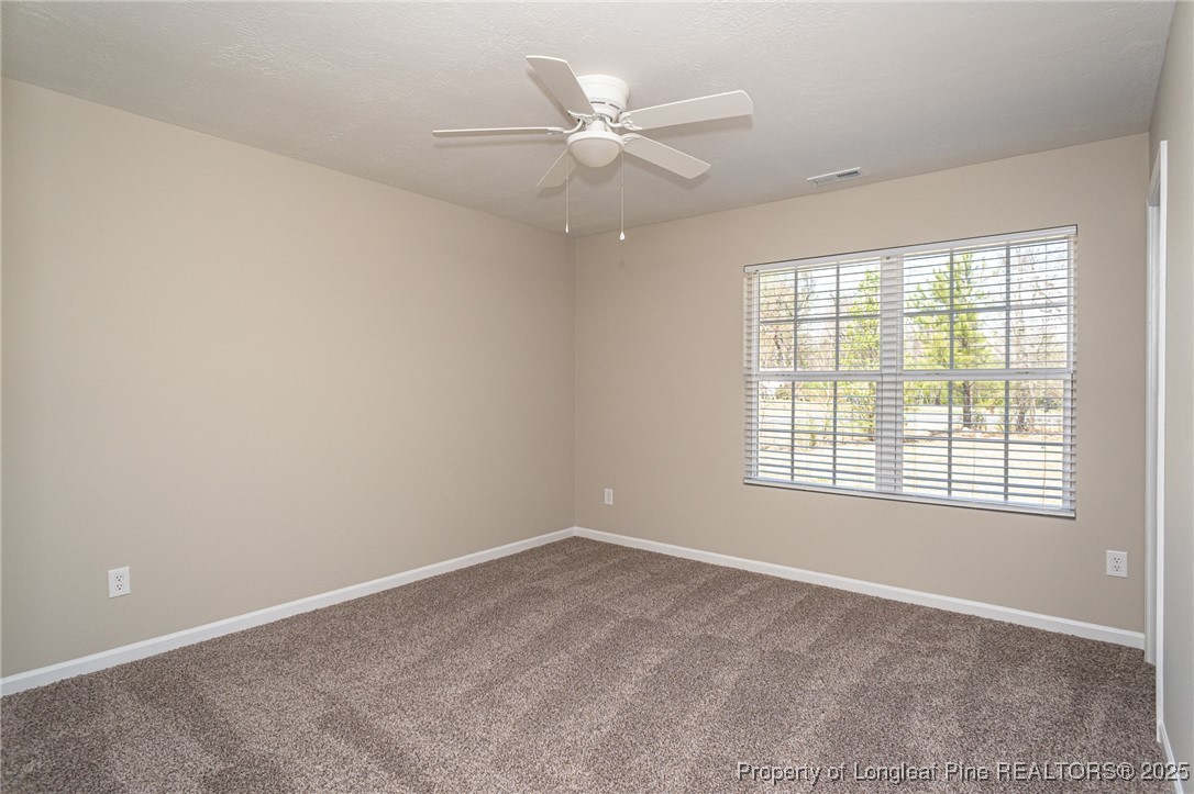 2830 John McMillan Road Hope Mills, NC 28348 - Photo 33 of 46 an empty room with a window and a ceiling fan