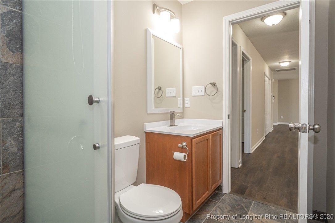 2830 John McMillan Road Hope Mills, NC 28348 - Photo 34 of 46 a bathroom with a sink a toilet and shower