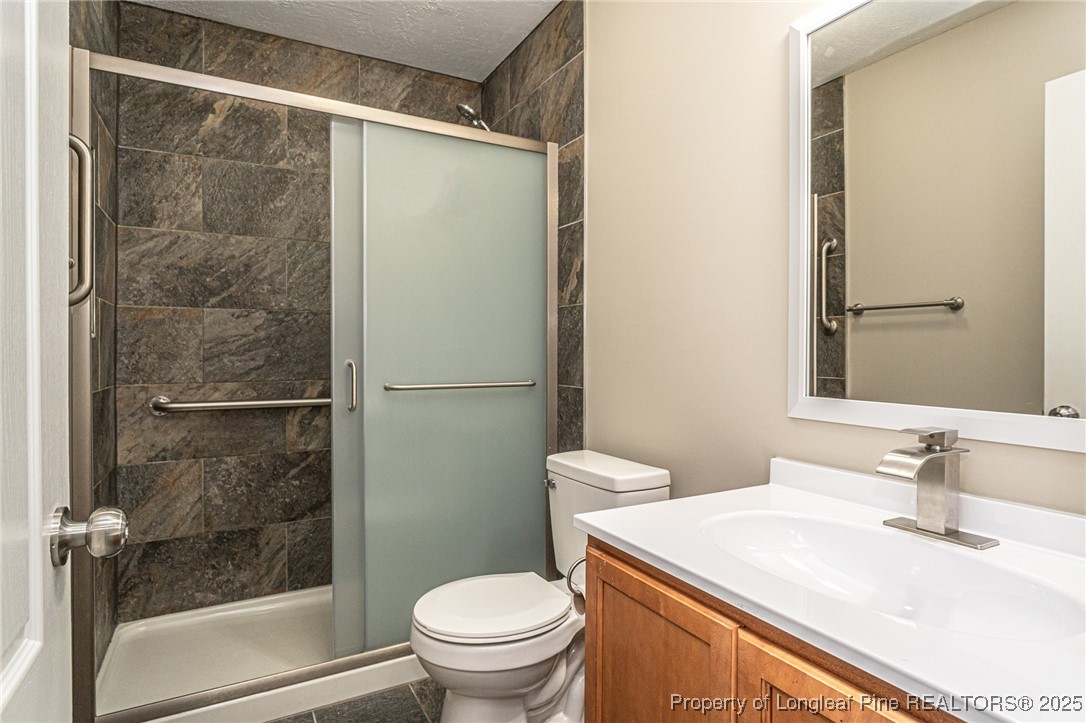2830 John McMillan Road Hope Mills, NC 28348 - Photo 35 of 46 a bathroom with a sink and a mirror