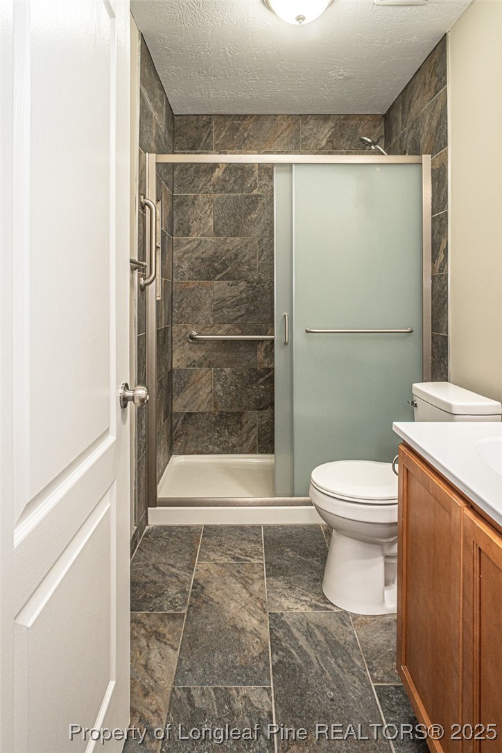 2830 John McMillan Road Hope Mills, NC 28348 - Photo 36 of 46 a bathroom with a shower and a toilet