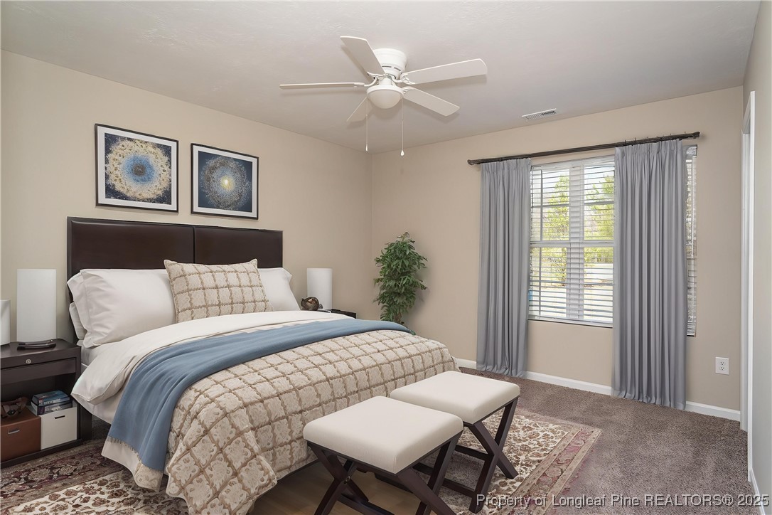 2830 John McMillan Road Hope Mills, NC 28348 - Photo 7 of 46 a bedroom with a large bed and a window