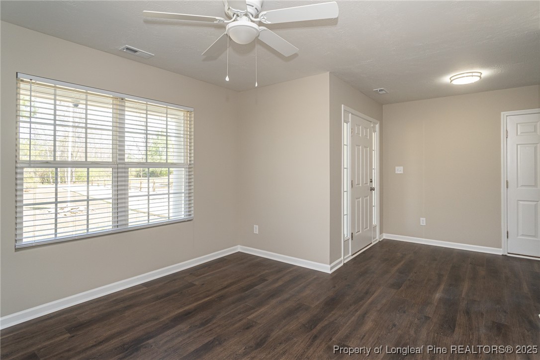 2830 John McMillan Road Hope Mills, NC 28348 - Photo 9 of 46 a view of an empty room with wooden floor and a window