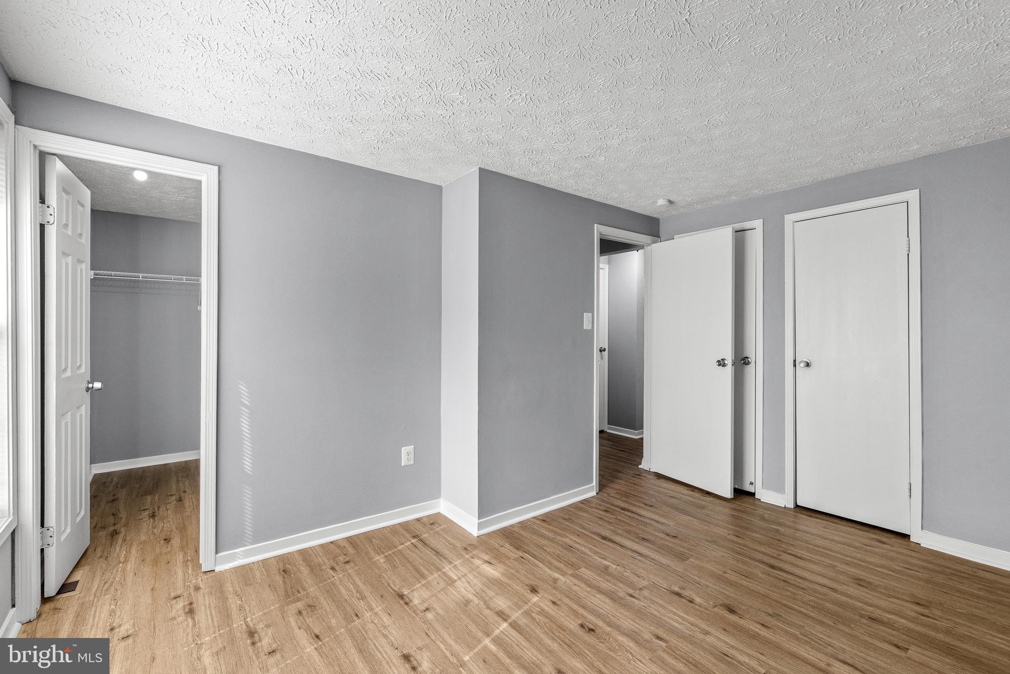 9479 Inaugural Drive King George, VA 22485 - Photo 15 of 26 a view of an empty room with wooden floor and a window