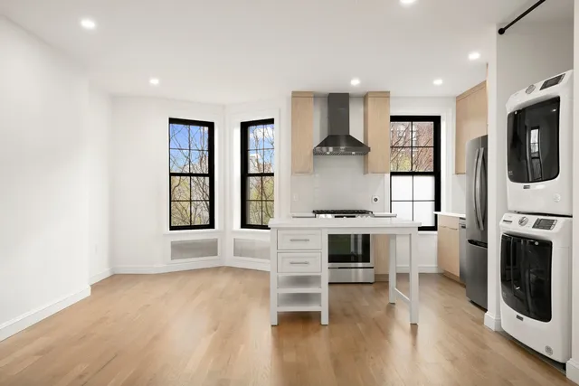 a view of kitchen with furniture and wooden floor