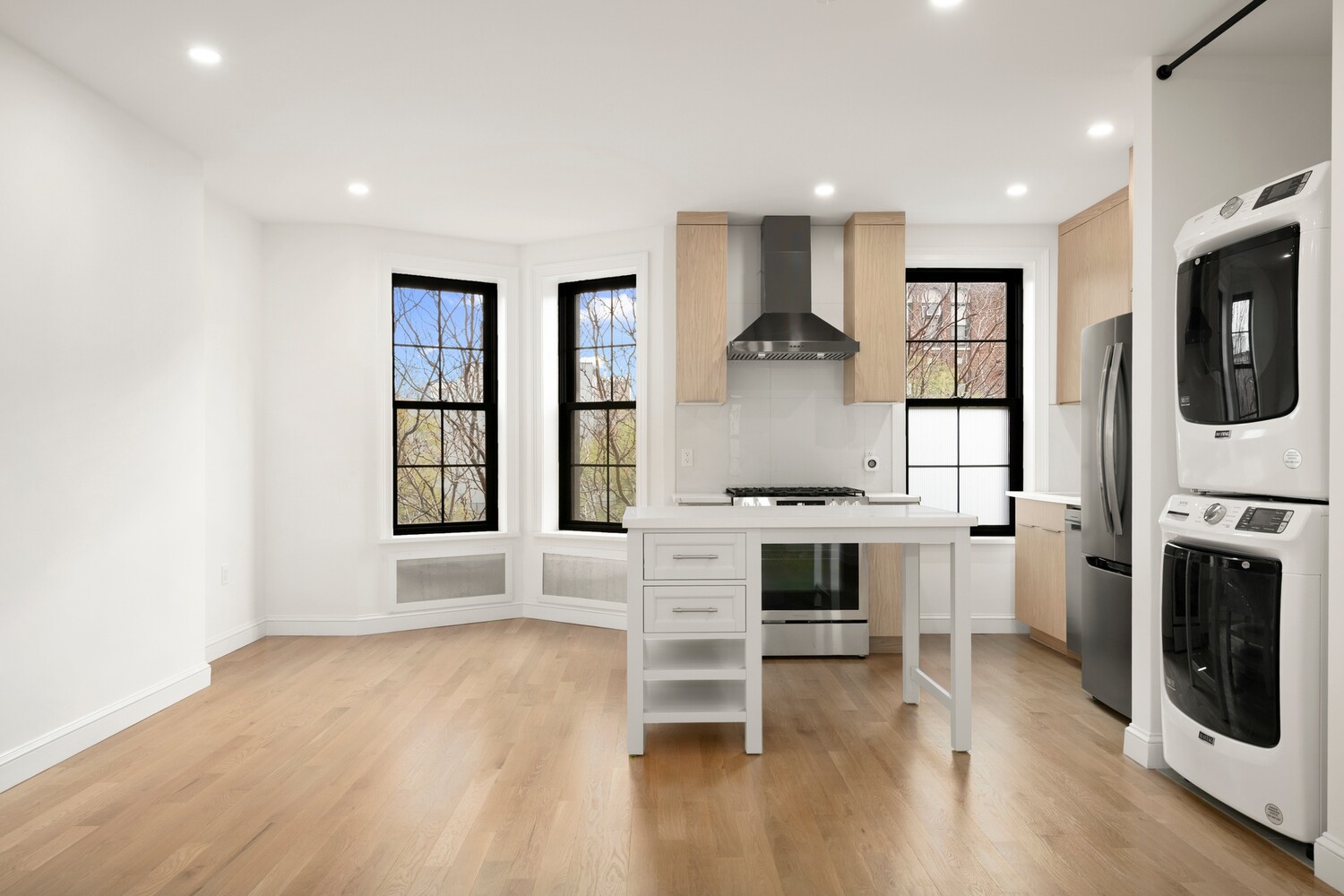 422 4th Avenue, Unit 3 Brooklyn, NY 11215 - Photo 3 of 11 a large white kitchen with window and stainless steel appliances