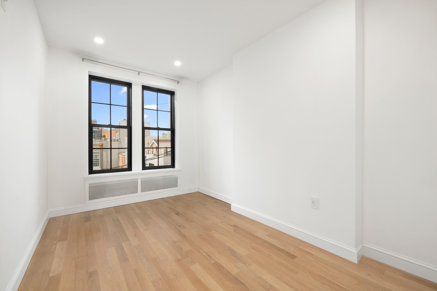 422 4th Avenue, Unit 3 Brooklyn, NY 11215 - Photo 5 of 11 an empty room with wooden floor and windows