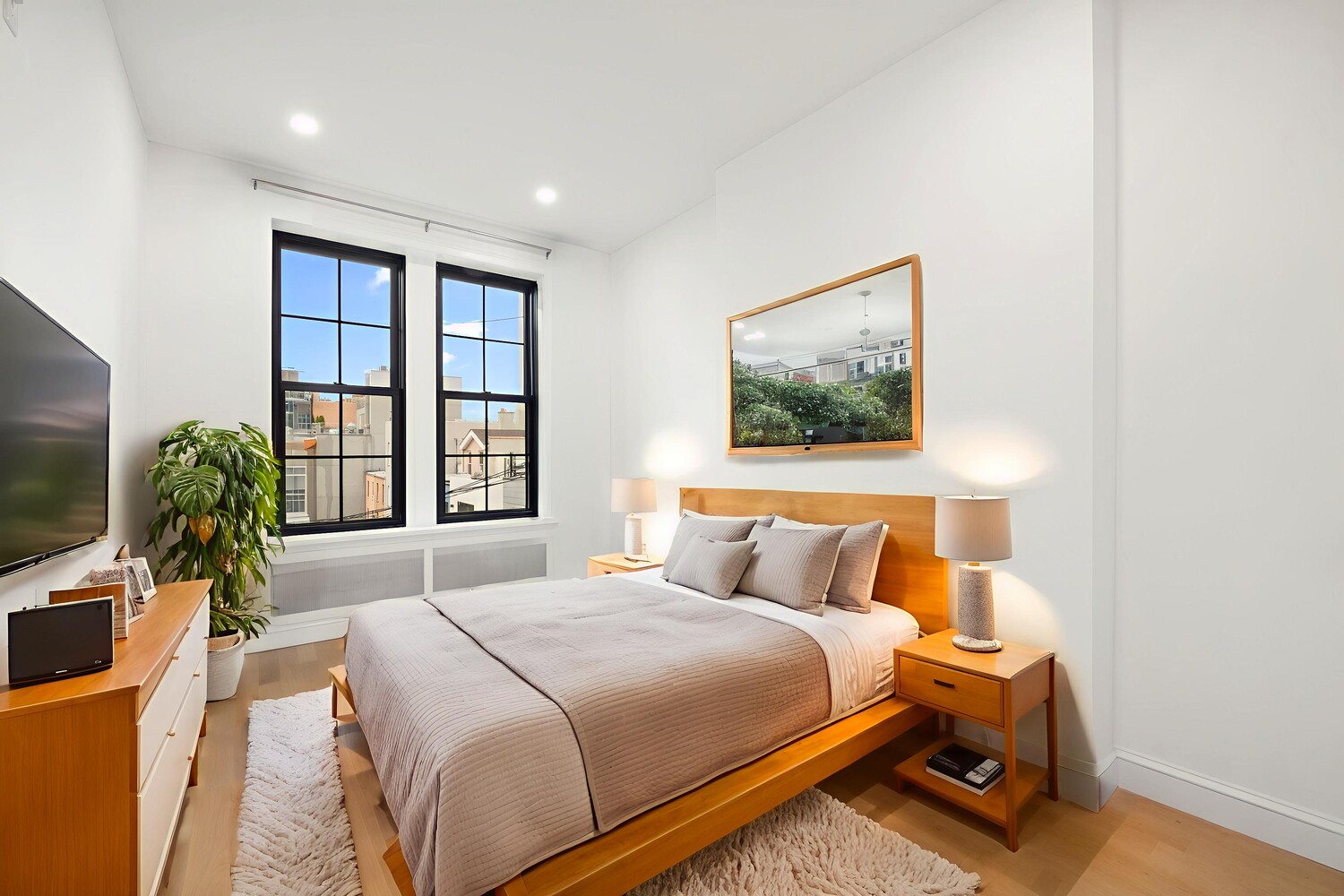 422 4th Avenue, Unit 3 Brooklyn, NY 11215 - Photo 7 of 11 a bedroom with a balcony a bed and a flat screen tv