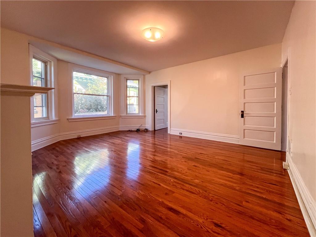 926 Savannah Avenue, Unit 2 Regent Square, PA 15221 - Photo 11 of 13 an empty room with wooden floor and windows