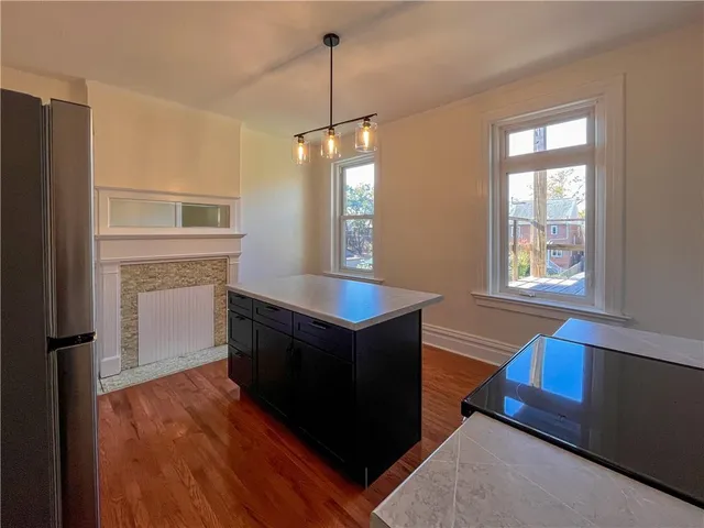 a kitchen with stainless steel appliances granite countertop a stove a sink and a refrigerator