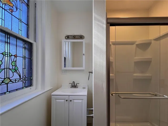 a bathroom with a shower and a sink