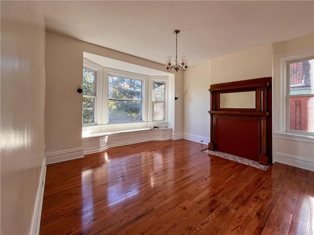 926 Savannah Avenue, Unit 2 Regent Square, PA 15221 - Photo 10 of 13 a view of an empty room with wooden floor and a window