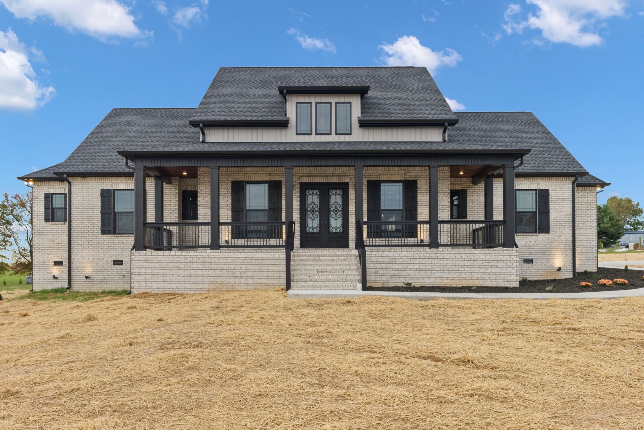 a view of a brick house with large windows