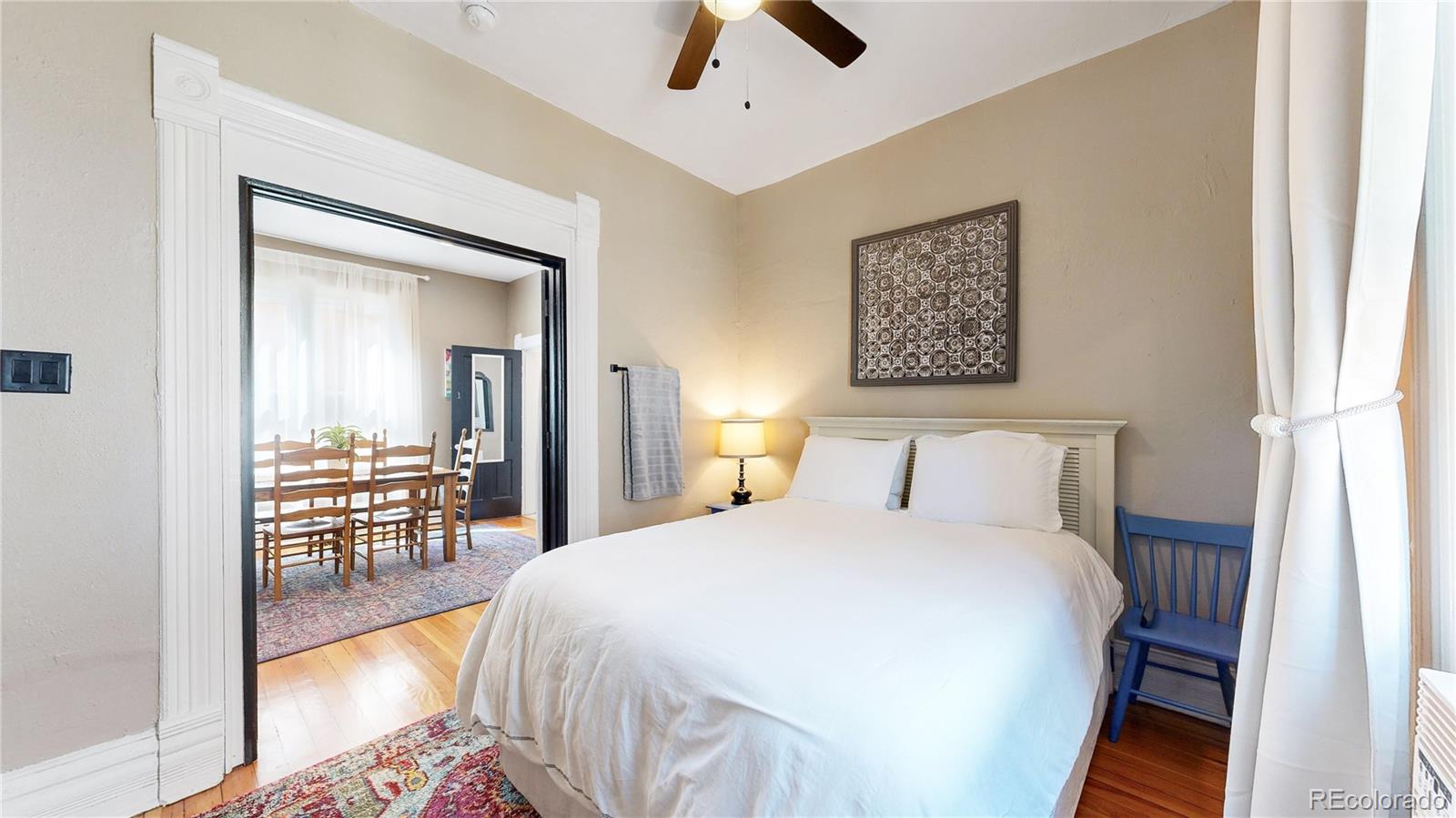 2733 Humboldt Street Denver, CO 80205 - Photo 11 of 40 a bedroom with a bed and a chandelier