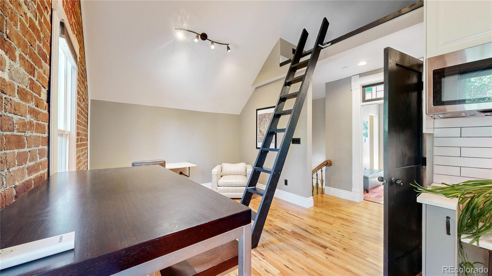 2733 Humboldt Street Denver, CO 80205 - Photo 14 of 40 a view of a hallway with furniture and wooden floor