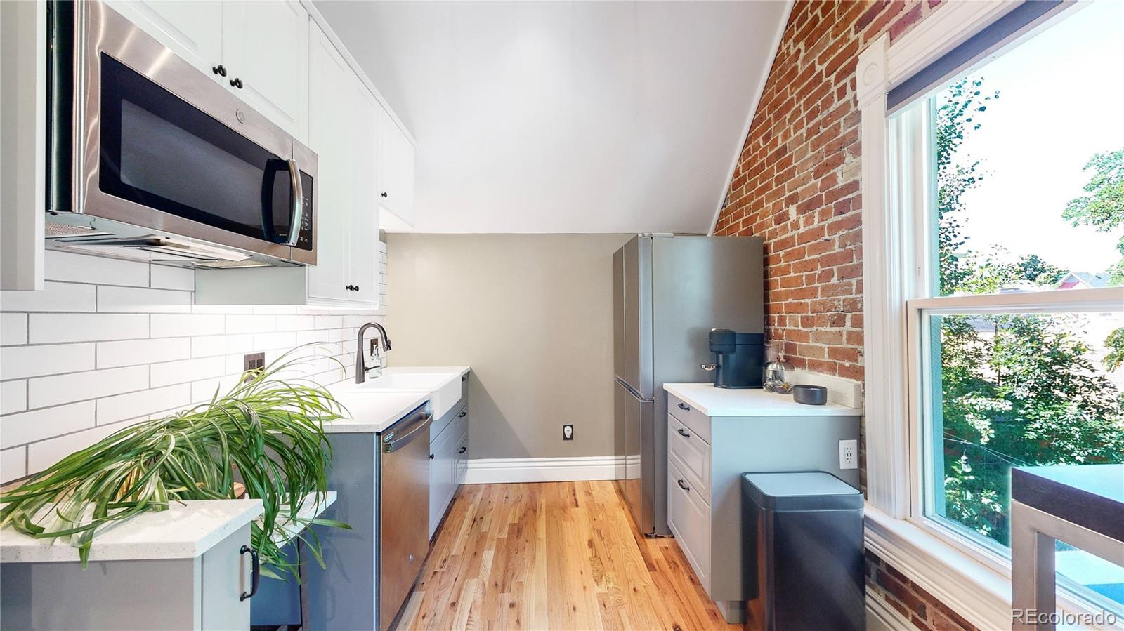 2733 Humboldt Street Denver, CO 80205 - Photo 18 of 40 a living room with a couch and a flat screen tv