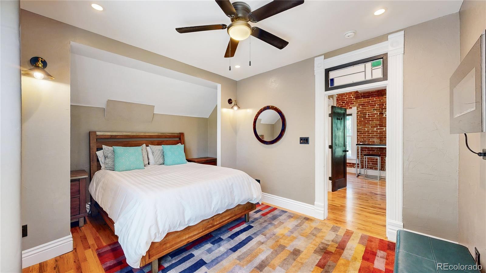 2733 Humboldt Street Denver, CO 80205 - Photo 24 of 40 a bedroom with a large bed and a chandelier