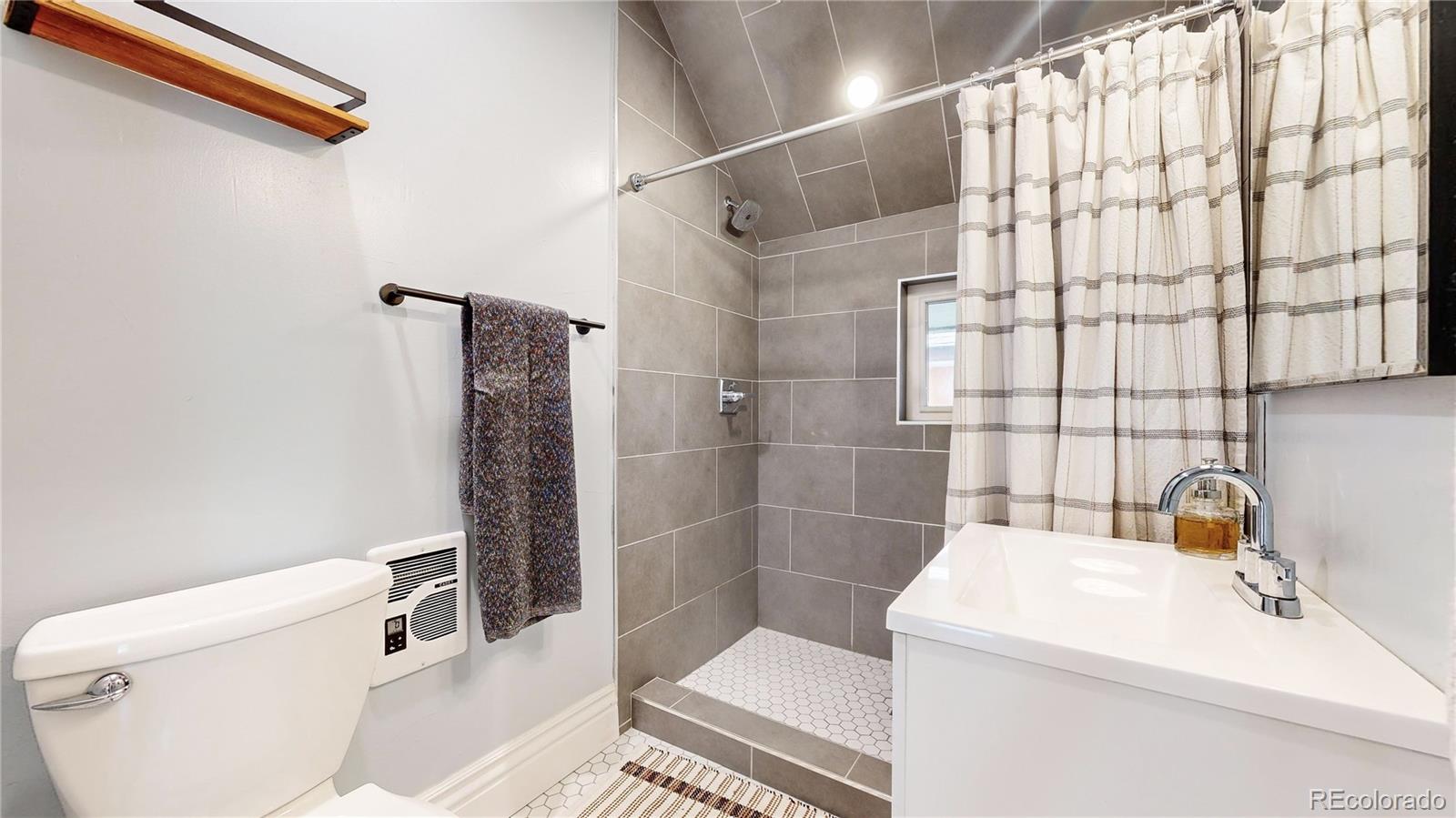 2733 Humboldt Street Denver, CO 80205 - Photo 25 of 40 a bathroom with a sink a toilet and shower