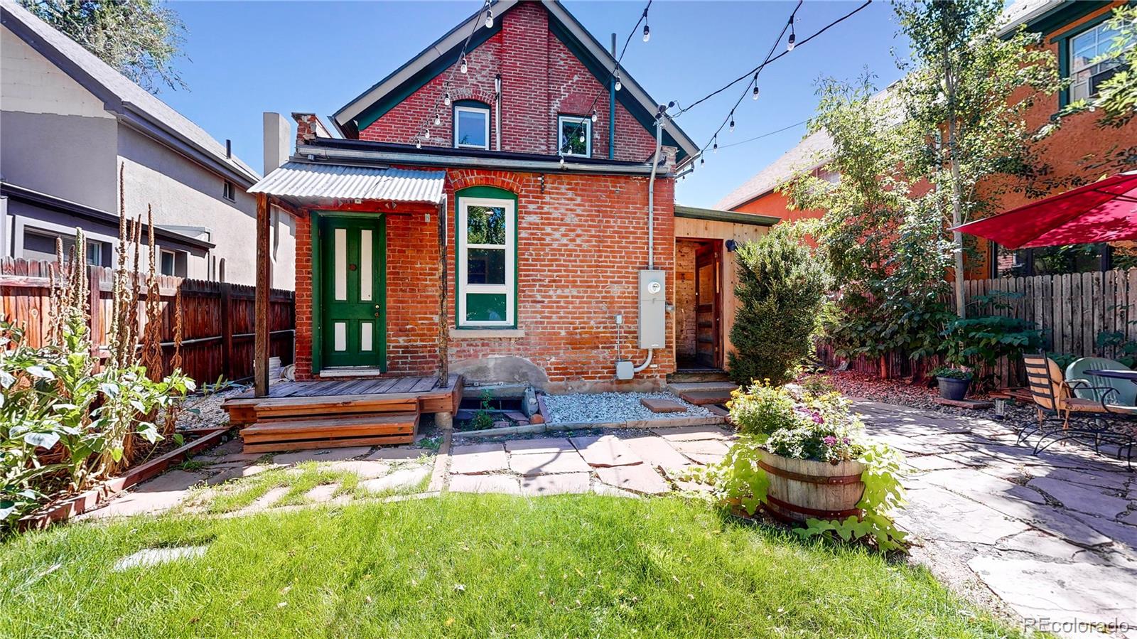 2733 Humboldt Street Denver, CO 80205 - Photo 28 of 40 a front view of a house with yard and outdoor seating
