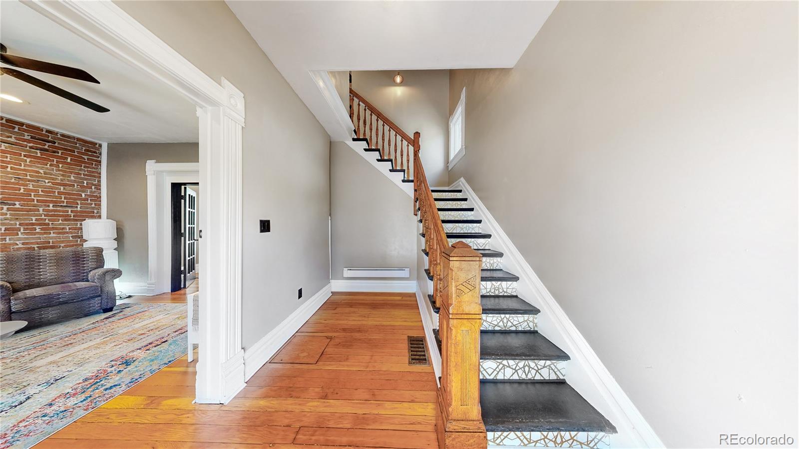 2733 Humboldt Street Denver, CO 80205 - Photo 4 of 40 a view of a hallway with entryway and wooden floor