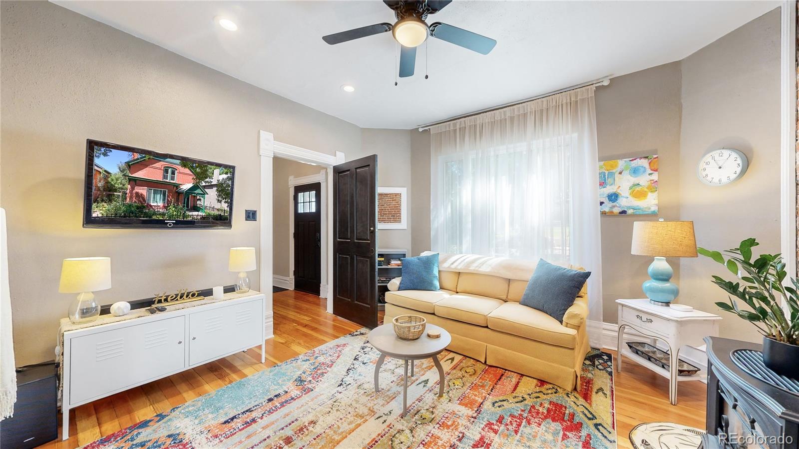 2733 Humboldt Street Denver, CO 80205 - Photo 6 of 40 a living room with furniture and a flat screen tv