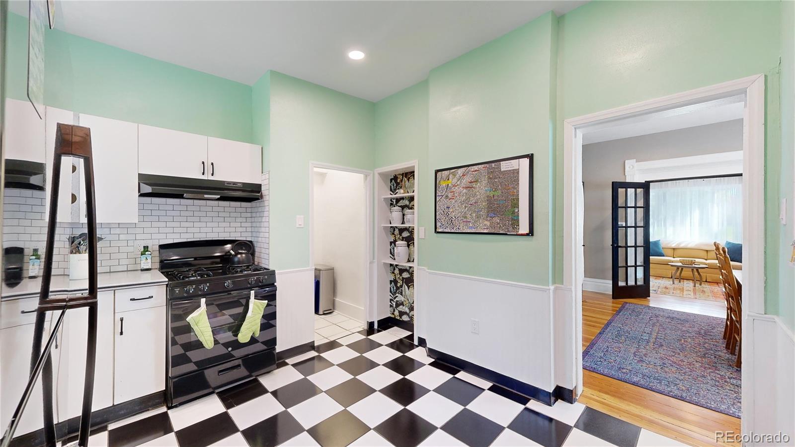 2733 Humboldt Street Denver, CO 80205 - Photo 10 of 40 a kitchen with stainless steel appliances granite countertop a refrigerator and a stove top oven