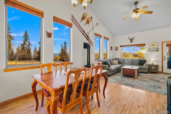 a dining room with furniture and wooden floor