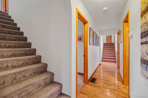 a view of entryway and hall with wooden floor