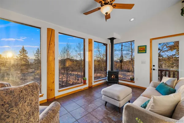 a living room with furniture and large windows