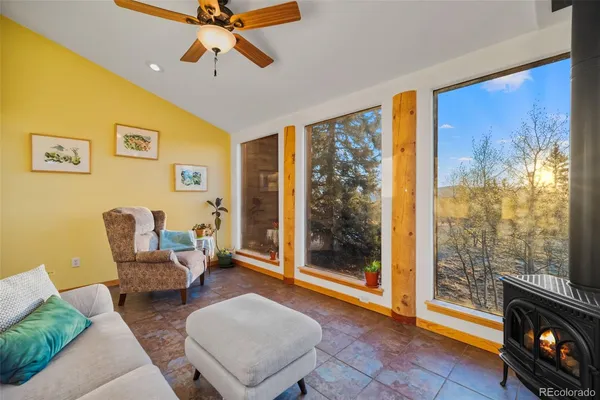 a living room with furniture and a floor to ceiling window