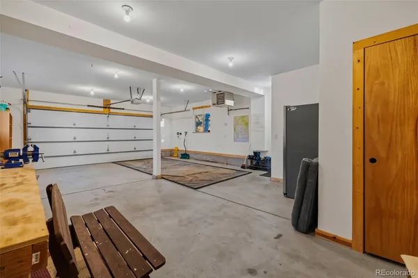 a view of a hall with wooden floor and furniture