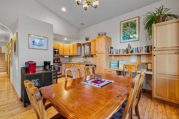a view of a dining room with furniture and a kitchen view