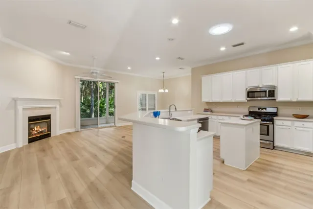 a kitchen with a sink a stove a refrigerator and cabinets