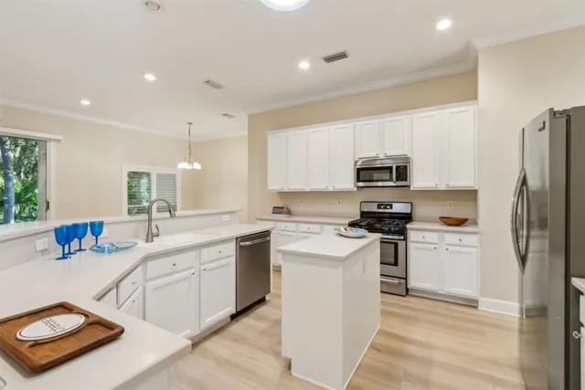 a kitchen with stainless steel appliances granite countertop a sink and stove top oven