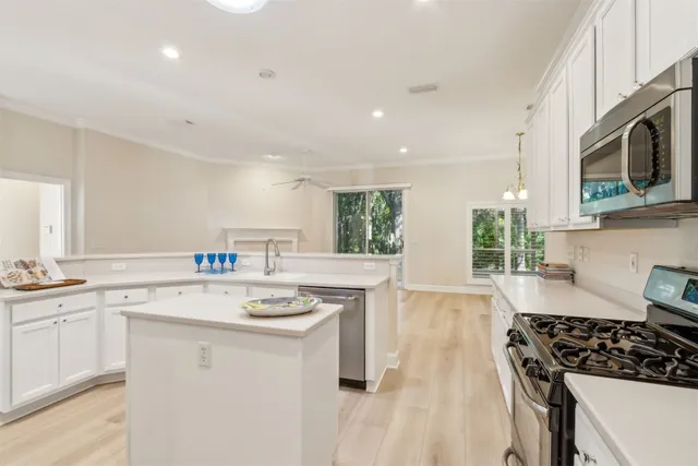 a kitchen with stainless steel appliances granite countertop a refrigerator and a sink
