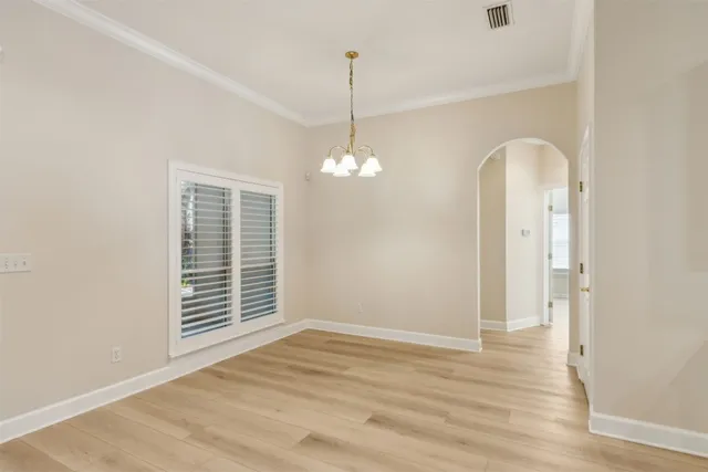 a open kitchen with white cabinets and white appliances