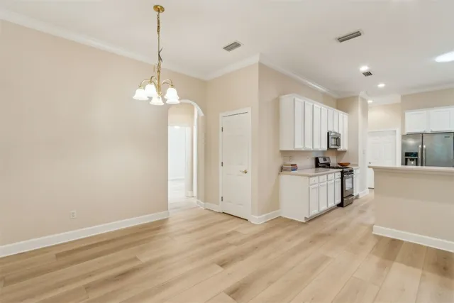 a view of a kitchen with a sink and a refrigerator