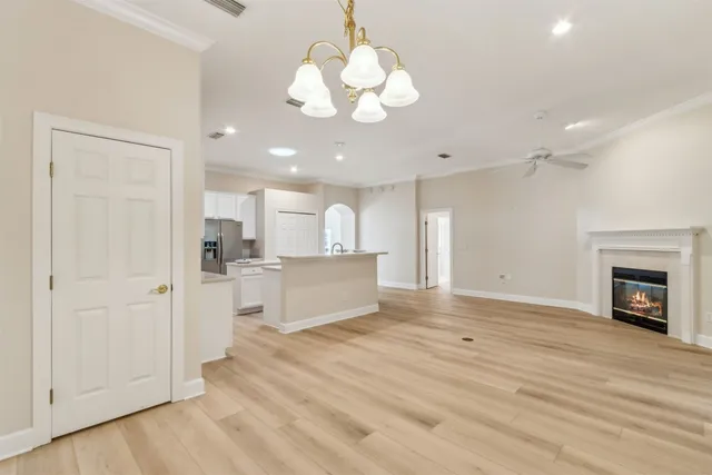 an empty room with floor to ceiling window and fireplace