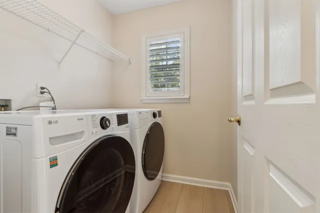 a view of a room with wooden floor and windows