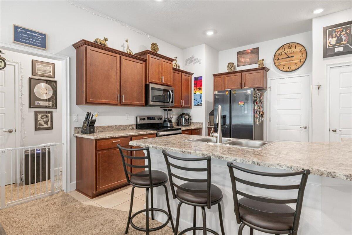 5348 Vespera Street Fort Pierce, FL 34951 - Photo 14 of 39 a kitchen with stainless steel appliances granite countertop a refrigerator and a stove top oven
