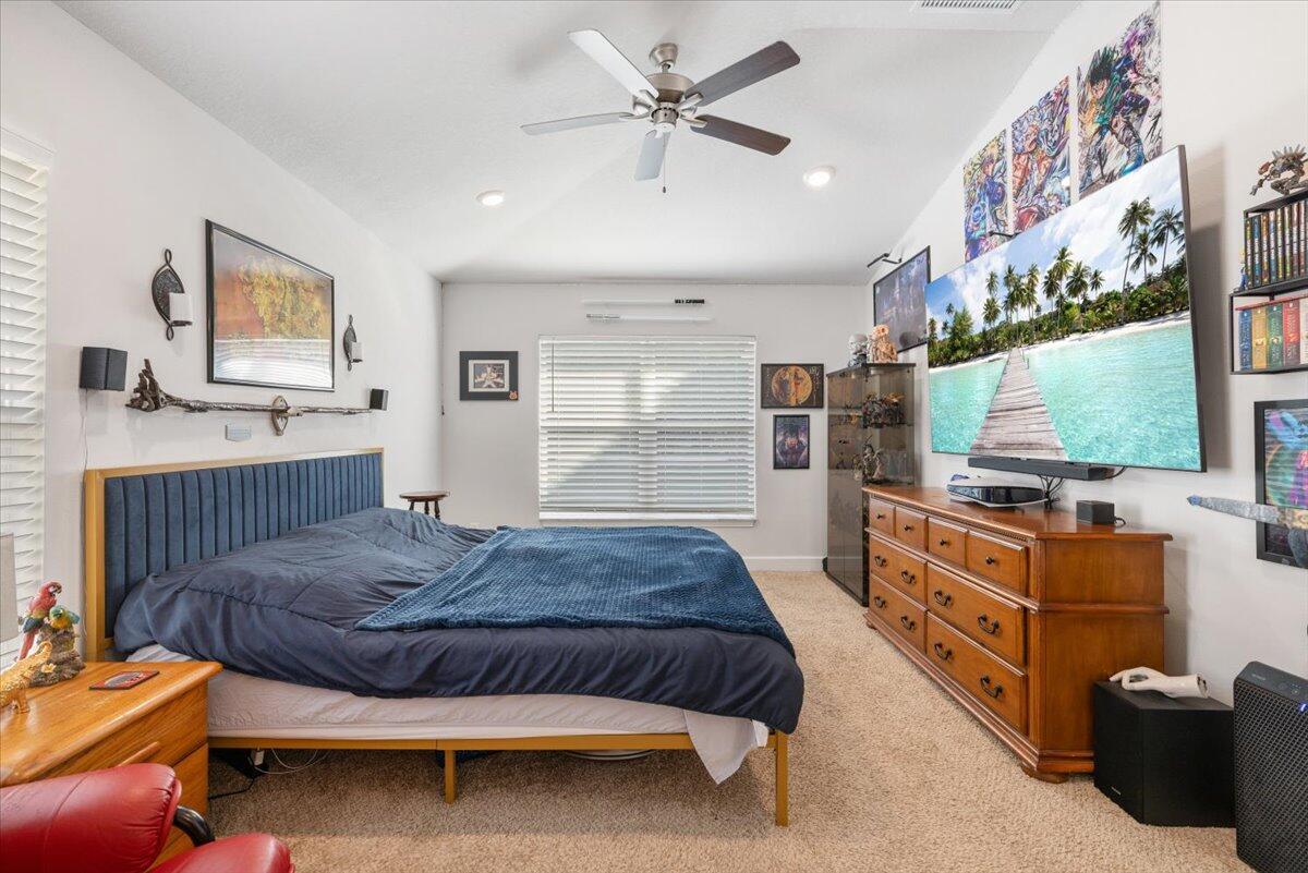 5348 Vespera Street Fort Pierce, FL 34951 - Photo 24 of 39 a bedroom with a bed and a flat screen tv