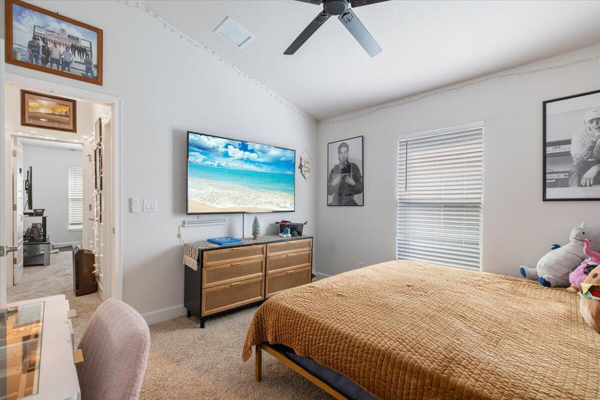 5348 Vespera Street Fort Pierce, FL 34951 - Photo 26 of 39 a bedroom with a bed and a flat screen tv