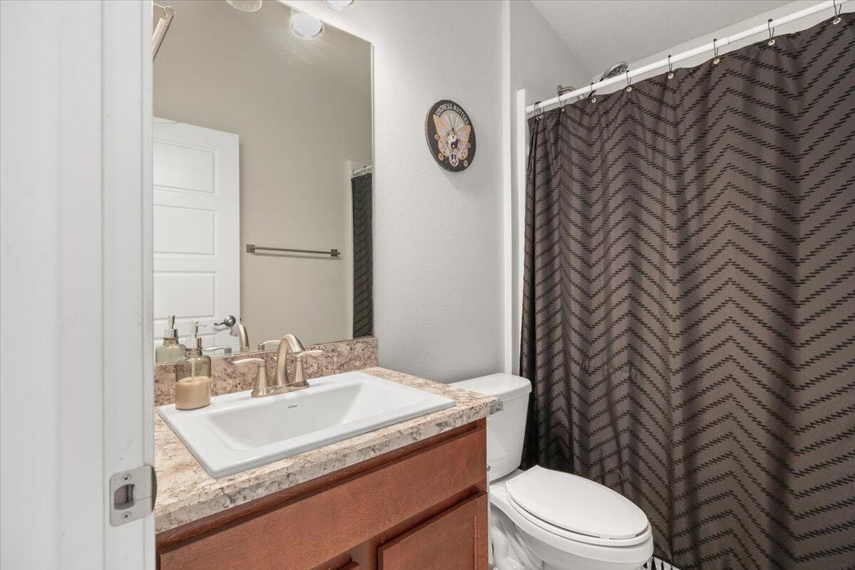 5348 Vespera Street Fort Pierce, FL 34951 - Photo 27 of 39 a bathroom with a granite countertop sink mirror vanity and toilet