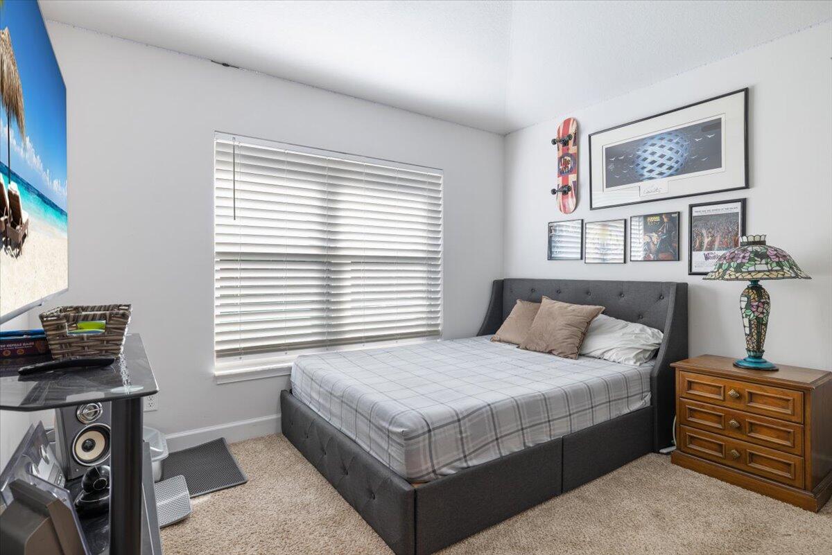 5348 Vespera Street Fort Pierce, FL 34951 - Photo 28 of 39 a bedroom with a bed and a tv on the dresser