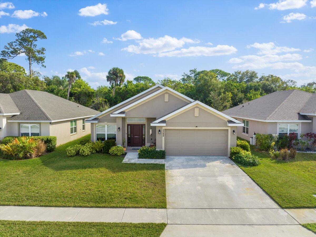 5348 Vespera Street Fort Pierce, FL 34951 - Photo 3 of 39 a view of a yard in front of house