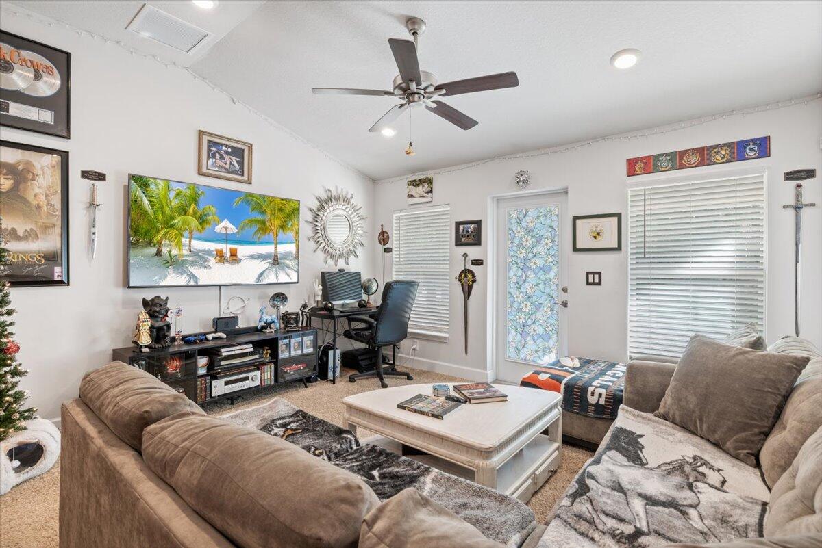 5348 Vespera Street Fort Pierce, FL 34951 - Photo 9 of 39 a living room with furniture a large window and a flat screen tv