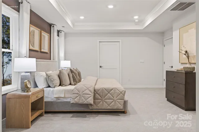 a spacious bedroom with a bed and a window