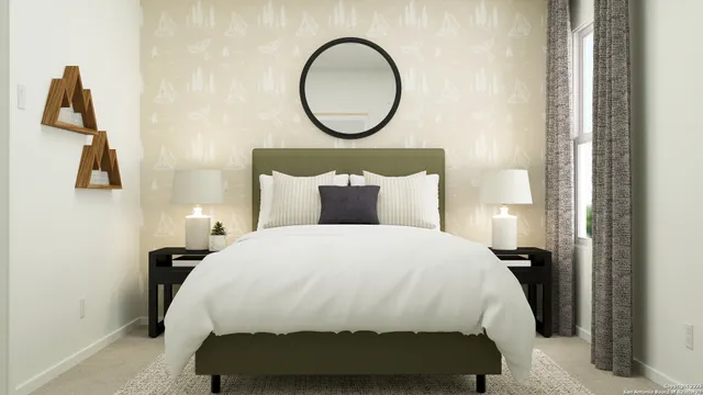 a bedroom with a bed and a painting on the wall