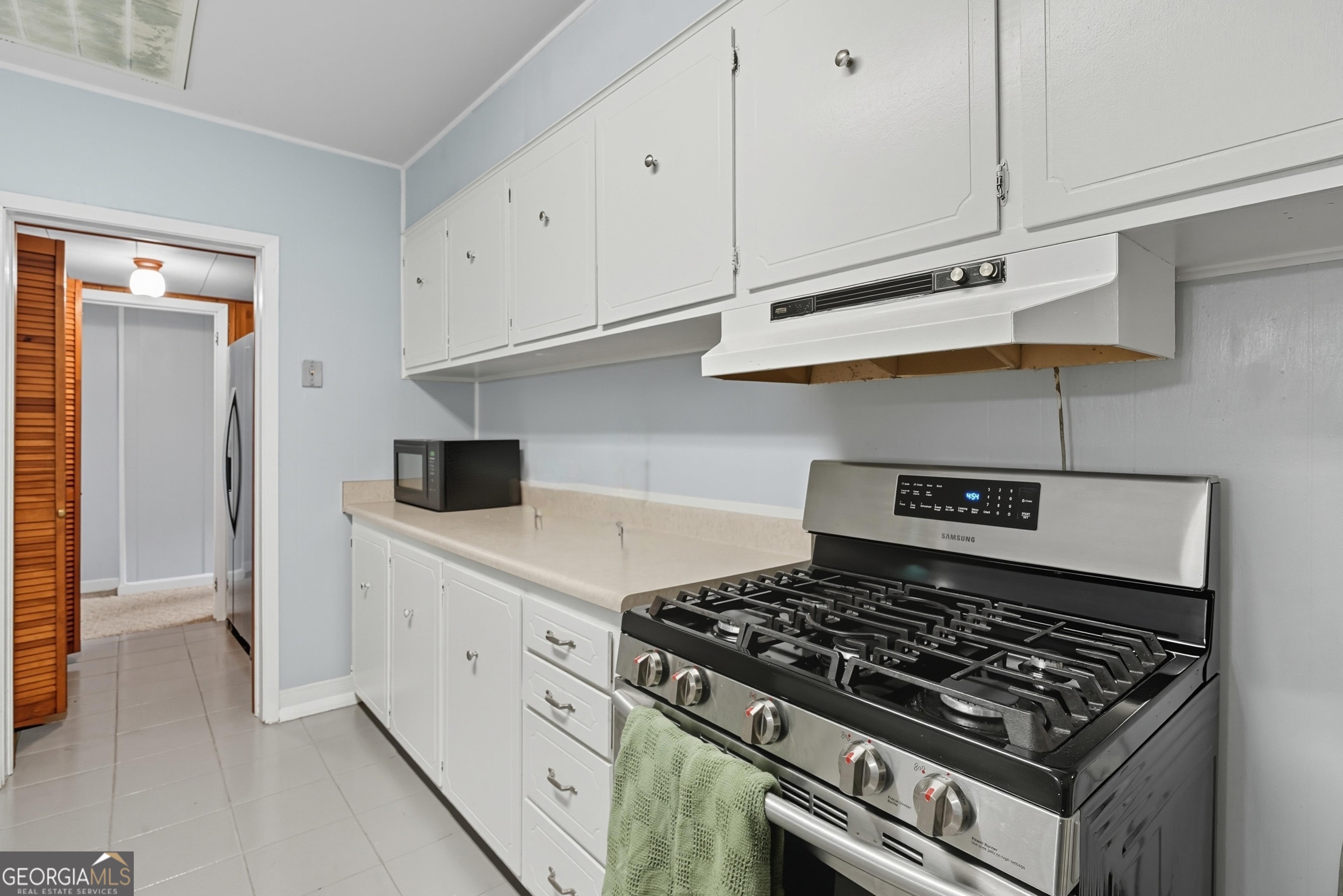 757 Old Screven Road Jesup, GA 31545 - Photo 11 of 38 a kitchen with white cabinets and appliances